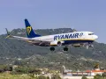 Ryanair ląduje na tle zielonych wzgórz i krzyża na szczycie.